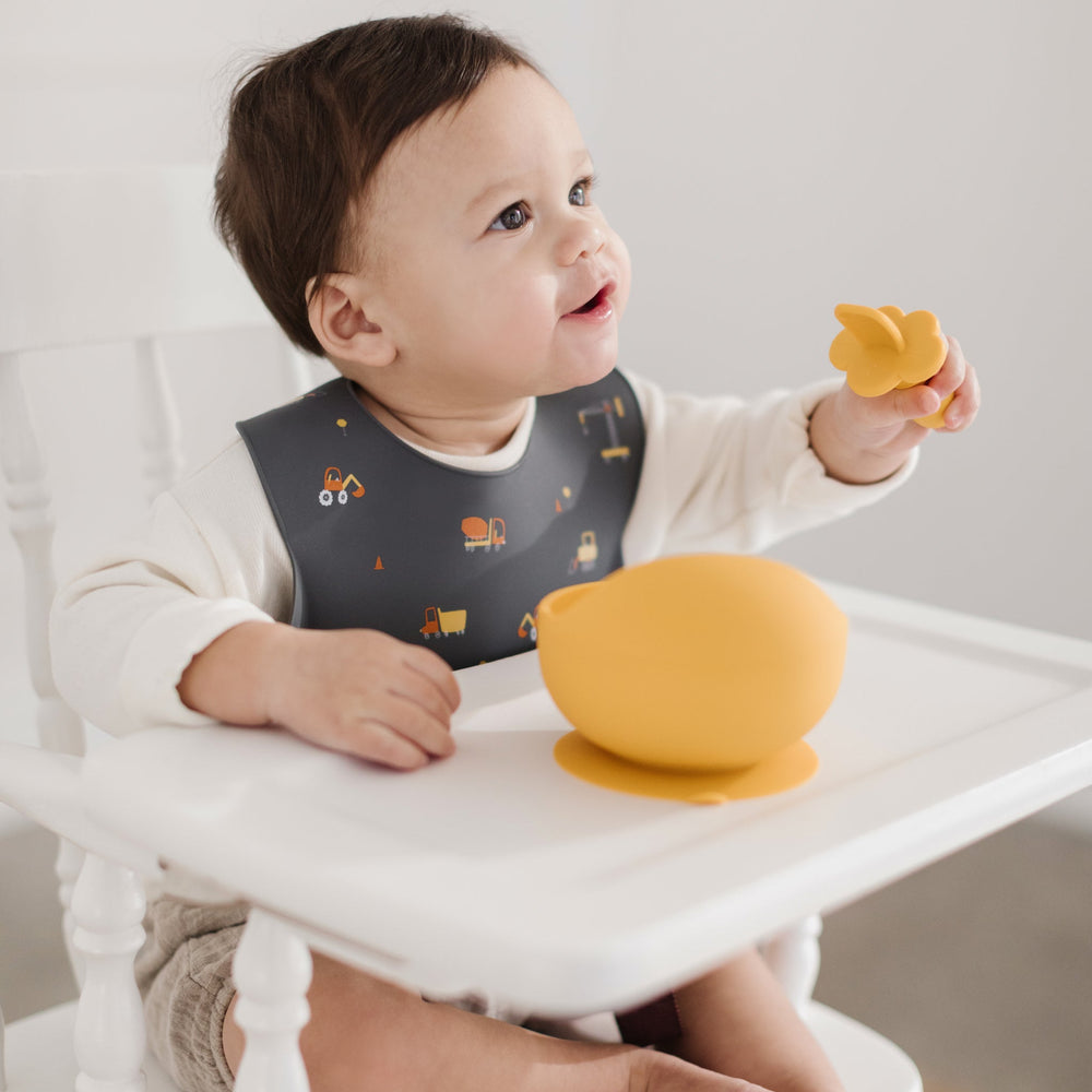Baby Eating Food in Silicone Construction Bib